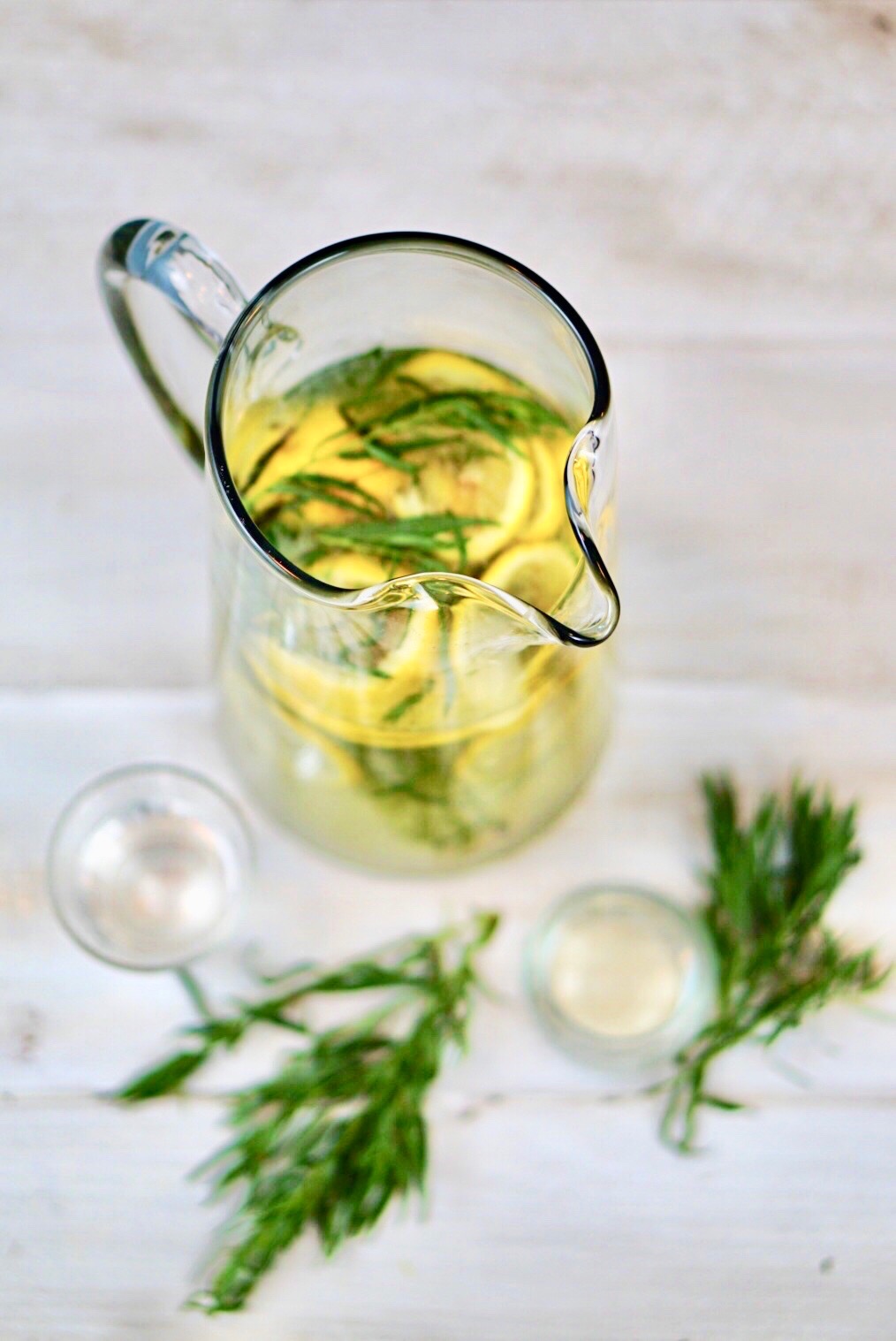 Tarragon Gin Lemonade exists on a higher plane than other gin and lemon cocktails. Its slight anise flavor enhances the lemon and highlights the herbaceous tones of the gin. Add in a bit of Elderflower and the result is a bright, crisp cocktail that is perfect for a hot summer’s evening!~By Wet Whistle Drinks by Darla Bentley