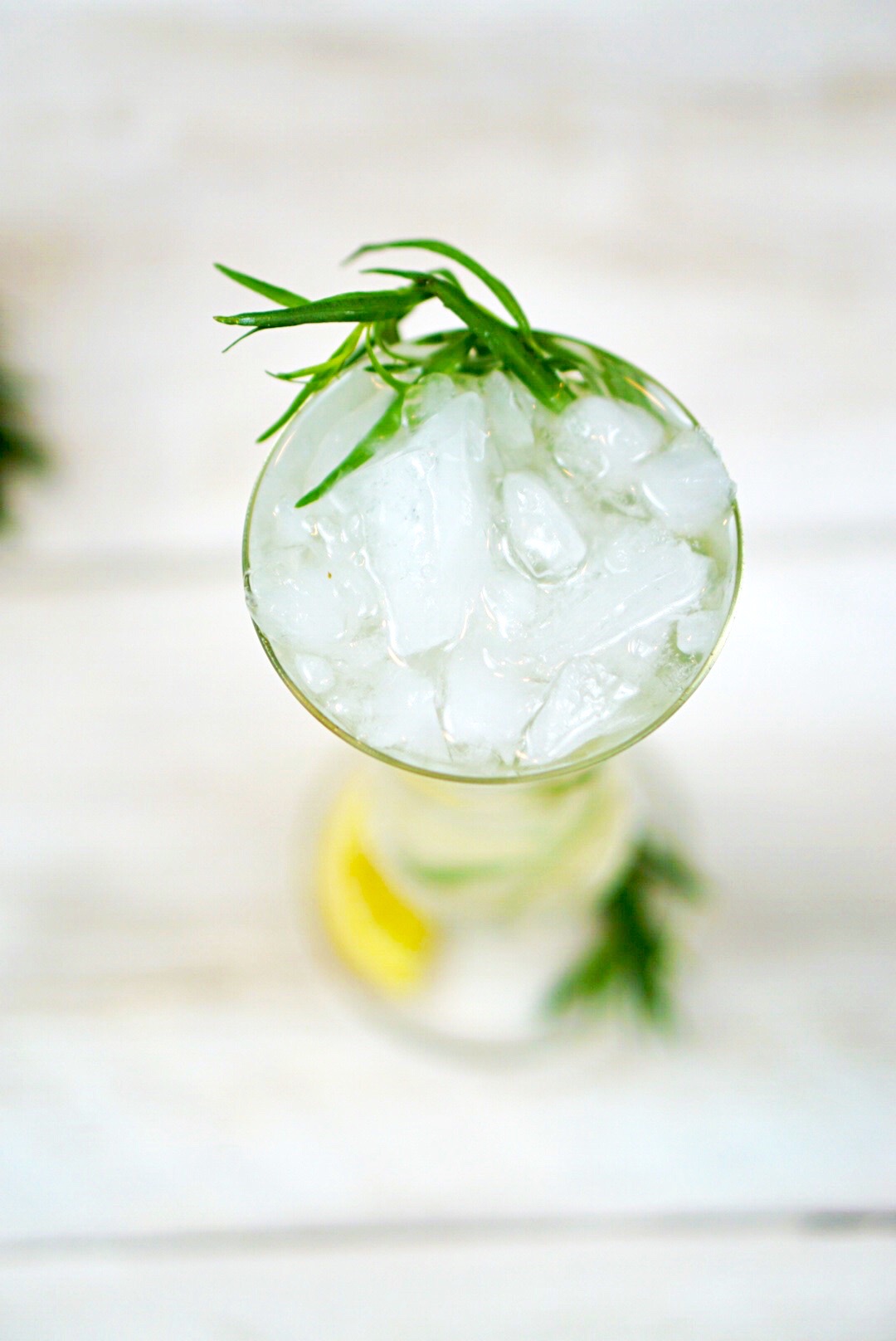 Tarragon Gin Lemonade exists on a higher plane than other gin and lemon cocktails. Its slight anise flavor enhances the lemon and highlights the herbaceous tones of the gin. Add in a bit of Elderflower and the result is a bright, crisp cocktail that is perfect for a hot summer’s evening!~By Wet Whistle Drinks by Darla Bentley